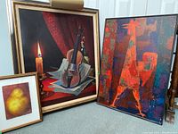 Three framed artworks including the original oil painting of a violin with candle, a colorful framed rooster print, and a small framed pear painting by Thelma Rosner.