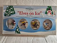 Front of box showing four elf figurines from Department 56 Elves on Ice set
