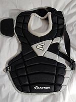 Front view of Easton black and grey padded catchers chest protector showing Easton logo and adjustable straps.
