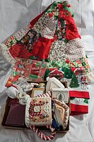 Photo showing the patchwork Christmas tree skirt and assorted Christmas items including ceramic plates and decorations.