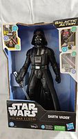 Front view of boxed Darth Vader Galactic Action figure with light-up eyes and sound effect features.