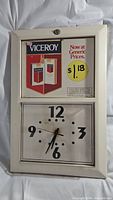 Full view of the vintage Viceroy clock showing advertising and clock face.