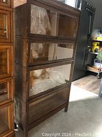 Front view of four glass‐front compartments with wood framing and glass doors.