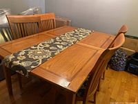 Assembled table with two leaves inserted and four chairs around
