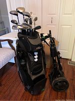 Full view of golf bag loaded with clubs and adjacent pull cart