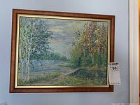 Framed oil painting of a landscape with trees and water, showing the full artwork and frame.