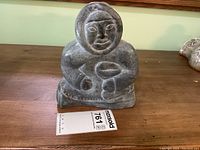 Front view of carving with identification tag visible