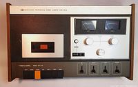 Front view of the Realistic SCT-6C cassette player showing tape slot, control buttons, VU meters, control knobs, and switches.