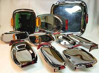 Front view showing all 10 stainless steel trays and platters with burgundy and caramel bakelite handles arranged on white background.