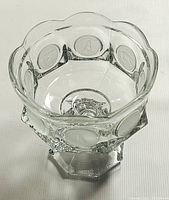 Top-down view of the goblet showing scalloped rim and frosted coin medallions around the body.