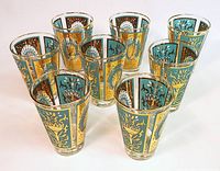 Set of 8 tumblers with peacock pattern in turquoise and gold with gilded rims, arranged in a group showing consistent decoration.