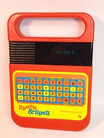 Front view of Texas Instruments Speak & Spell device showing red and yellow case, handle, keypad with blue and orange keys, digital screen displaying 'MaxSold'.