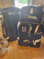 Two black and white Rackdri Sport hockey bags side by side showing overall size, shape, and branding.