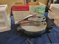 Front view of the Grand Wrap Flatbread Maker with original box and packaging foam visible.