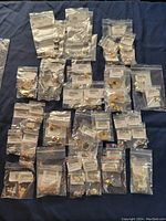 Overview of 58 pieces of assorted new costume earrings in individual sealed bags with descriptions.