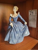 Front view of Royal Doulton figurine 'Fragrance' showing blue dress and detailed figure.