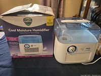 Vicks Cool Moisture Humidifier including original box, showing front and top view of humidifier.
