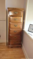 Front view of lingerie chest showing all six drawers and brass hardware