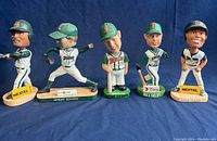 Front view of 5 Buffalo Bisons bobbleheads standing in a row showing detailed faces, uniforms, and bases