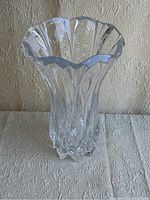 Front angled view of the clear lead crystal vase showing the fluted, wavy rim and twisted vertical swirl texture.