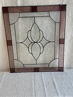 Front view of stained glass panel showing border design and central motif.
