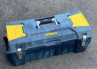 Front angled view of the Irwin branded large blue tool box with yellow top compartments, central black handle, and metal latches.