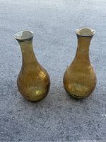 Photo of two large Vidrios San Miguel hand made glass vases, amber color, standing side by side showing front view
