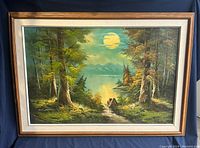 Full front image of framed oil painting showing the entire landscape scene with trees, path, moon, water, and mountains, highlighting colors and condition.