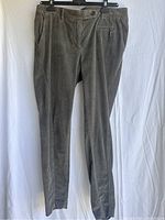 Front view of Brunello Cucinelli ladies pants showing grey cotton material, front button, zipper and side pocket details.