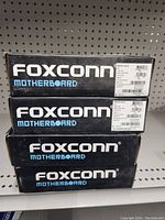 Stack of 4 Foxconn motherboard boxes with product label.