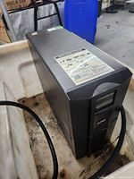 Front right angle showing UPS tower housing, LCD panel and attached power cable