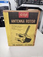 Front of CDE Antenna Rotor box showing branding, usage for TV and FM stereo, and seller location info.