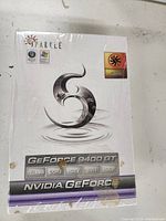 Front of the sealed retail box showing Sparkle branding and Nvidia GeForce 9400 GT details, including 1024MB DDR2 memory, HDTV, DVI, and HDCP support.