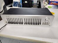 Front view of the Realistic equalizer showing all 10 frequency sliders and power button.