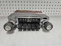 Front view of vintage Jeep AM car radio showing frequency dial, Jeep logo, and preset buttons.