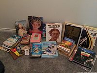 Wide view of all books in the lot, showing a variety of travel guides, historical and general interest titles organized on the floor.