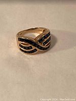 Front view showing three-row crossover channel setting of dark blue stones