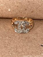 Front-facing view of ring showing double C design and pavé stones