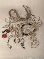 Group shot of all items as seen, chains, bracelets, pendants and earrings