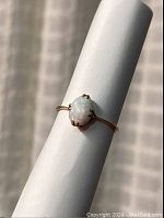 Front view showing oval opal and yellow gold band