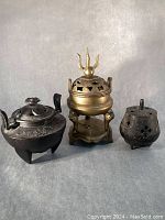 Group photo of three antique incense burners showing various materials and designs
