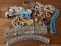Lot overview with rhinestone bracelets, pearl necklaces, earrings, rings, watch pendant and brooch