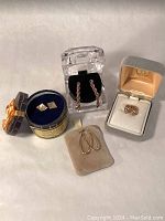 All four pairs shown in their original boxes and pouches on flat surface.