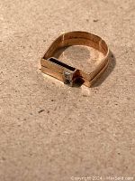 Ring front angled view showing flat top design and stones