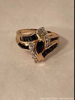 Front three-quarter view showing central marquise stone, diamond accents and channel-set stones