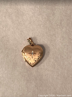 Closed front view on neutral background showing scalloped edge and engraved starburst