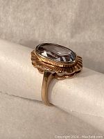 Three-quarter side view of ring showing bezel setting and profile