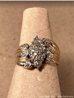 Front view showing central navette diamond cluster and grooved band design