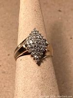 Front view of ring on stand showing diamond cluster