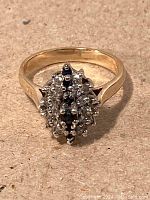 Front view showing cluster of white diamonds and central row of dark blue sapphires